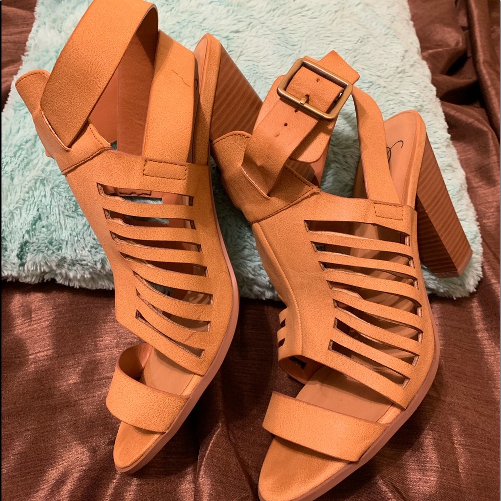 Tan strappy 3 inch heeled sandals.